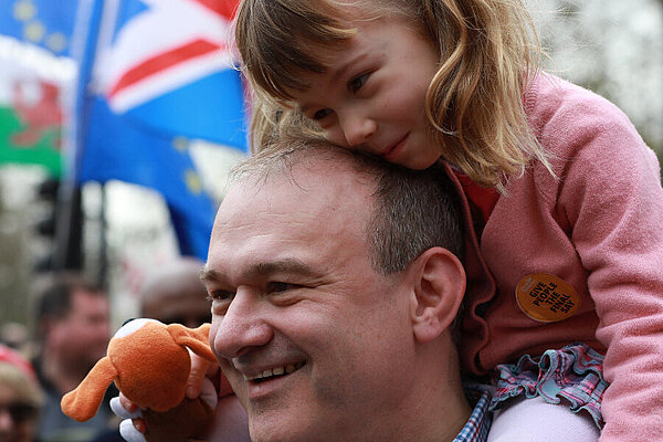 Ed Davey carrying a child on his shoulders