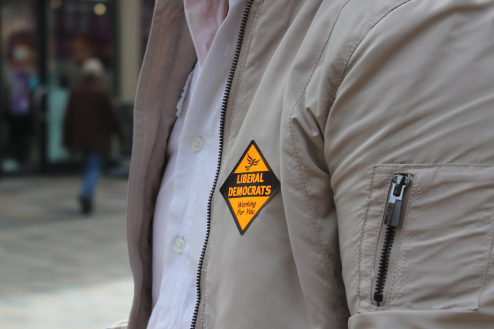 A person's jacket displaying a Liberal Democrat sticker